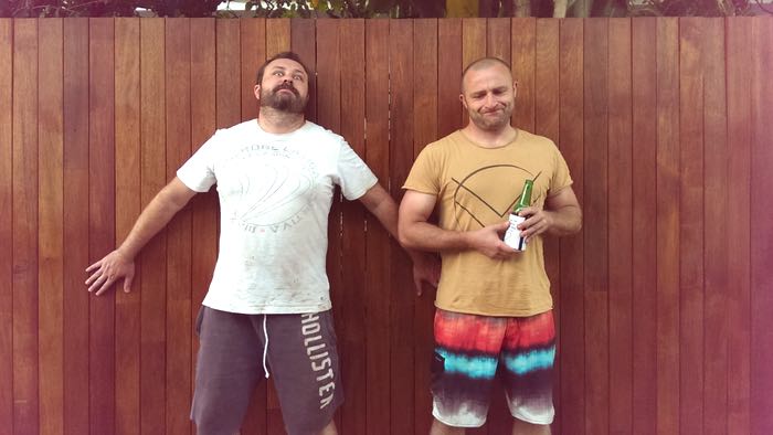 two tired gents resting against a jarrah fence, c. 2015