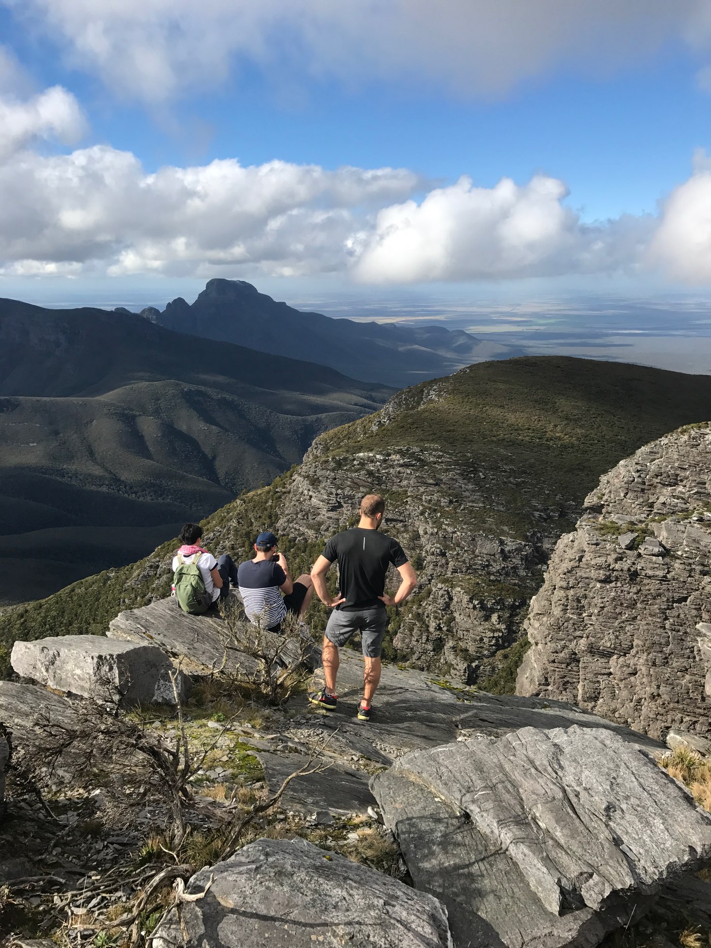 admiring the view of the mountain range from the summit