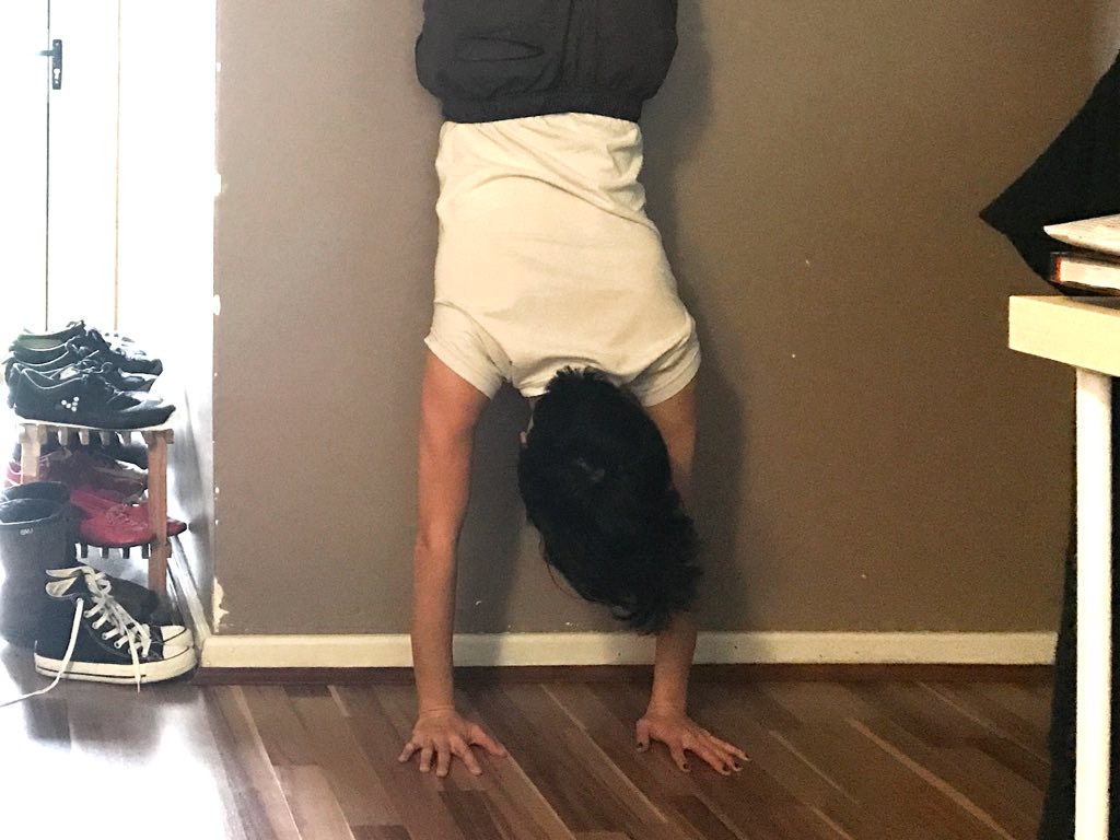 Doing a handstand next to a stinky shoe rack. Gross.