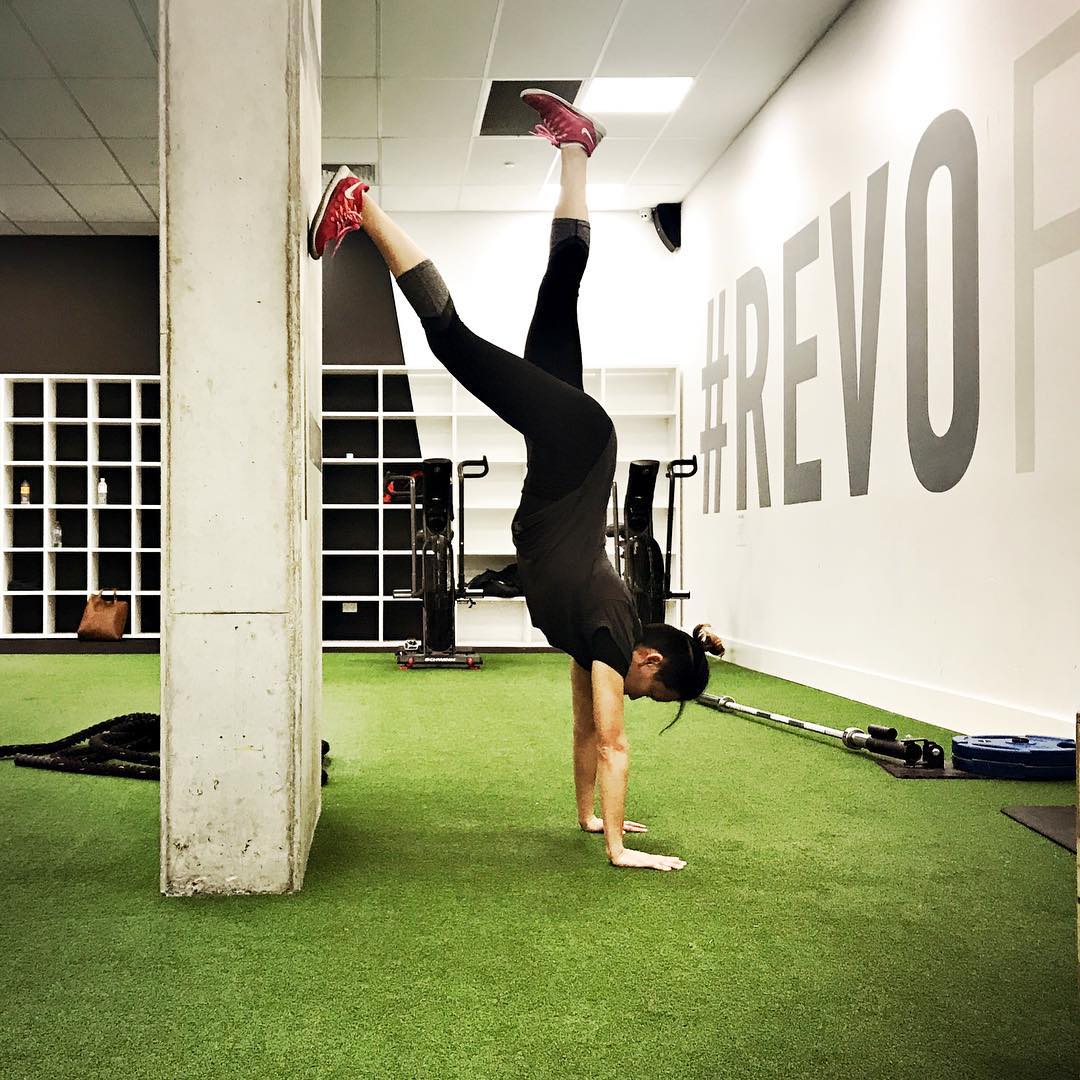 doing a handstand with "banana back" posture